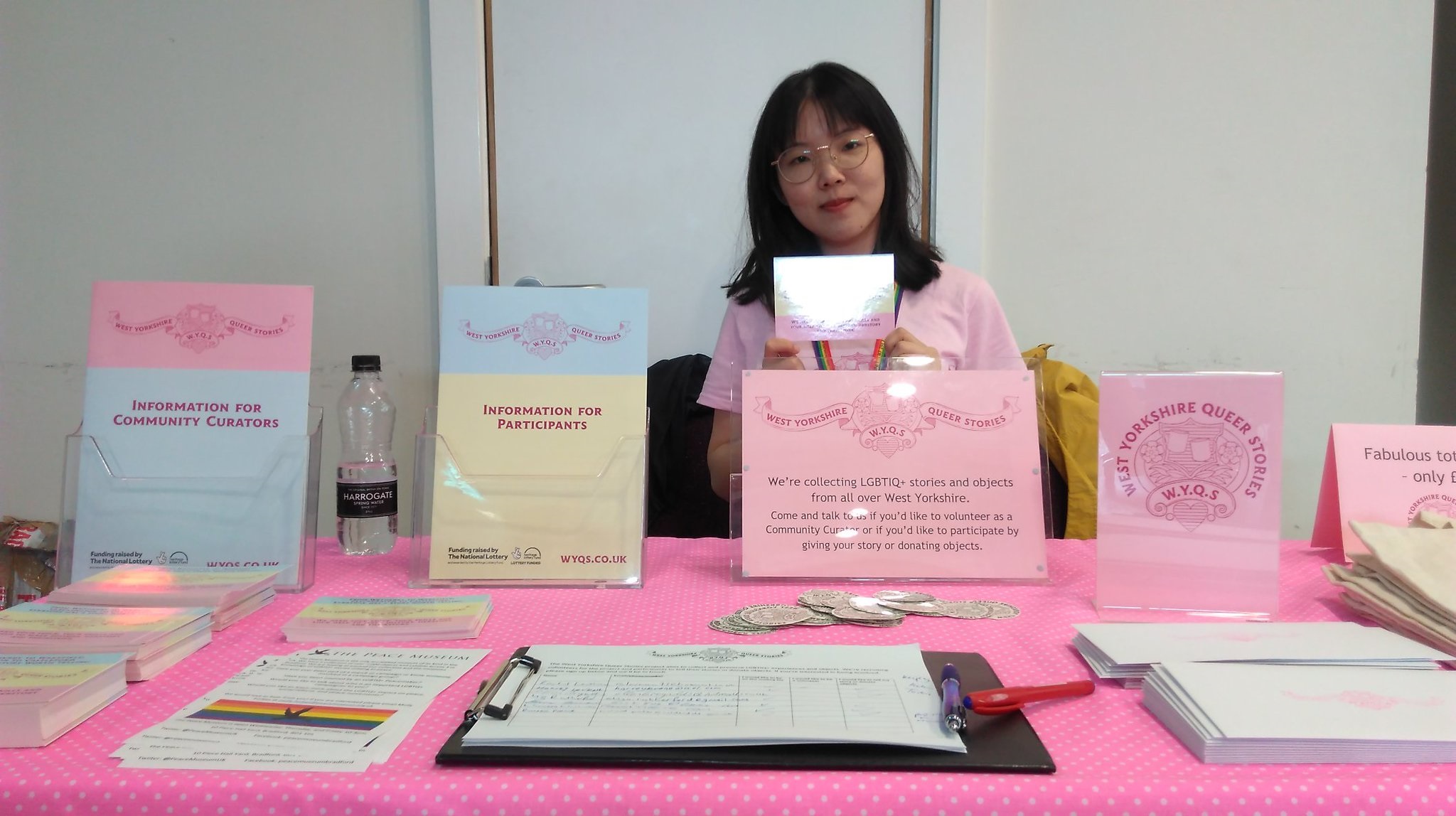 Volunteer Alva sits behind a WYQS stall