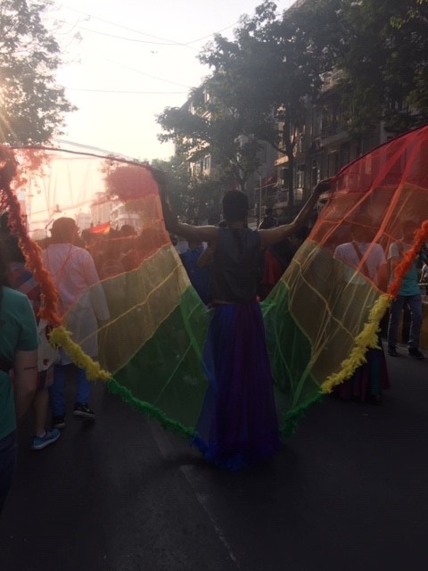 A marcher at Mumbai Pride wears a rainbow butterfly cape